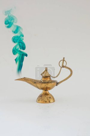 Photo for Brass vintage oil lamp on a solid white  background and green smoke smoke - Royalty Free Image