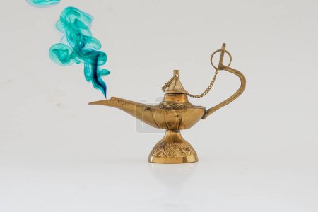 Photo for Brass vintage oil lamp on a solid white  background and green smoke - Royalty Free Image
