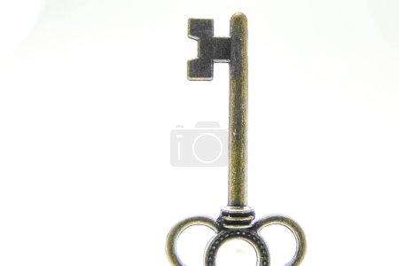 Photo for Old vintage antifuw key used for locking against a white background - Royalty Free Image