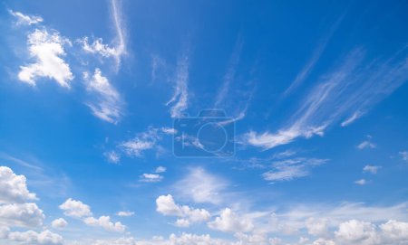 Panoramic view of clear blue sky and clouds, Blue sky background with tiny clouds. White fluffy clouds in the blue sky. Captivating stock photo featuring the mesmerizing beauty of the sky and clouds.