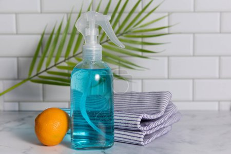 Glass spray bottle in the kitchen. Cleaning concept