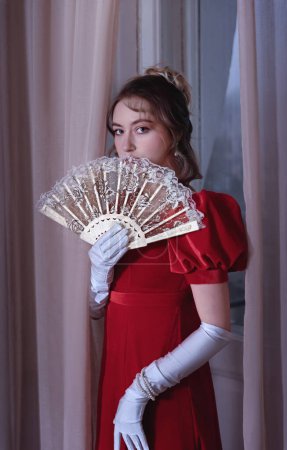 19th century. The concept of the life of a young aristocrat. Standing with fan