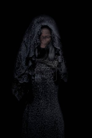 Photo for Scary old witch with absent face. Horror scene of a possessed zombie, woman in black dress, ghost on dark background. Halloween scary concept - Royalty Free Image
