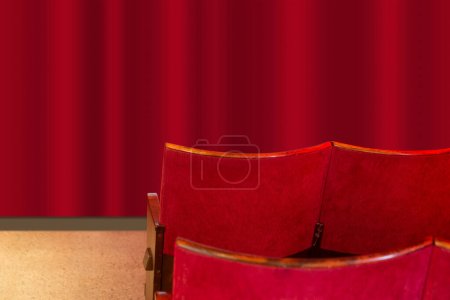 Photo for Vintage red cinema seats in front of red curtain - Royalty Free Image