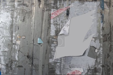Photo for Messy notice board or wall with remains of notes and posters, with copy space in middle - Royalty Free Image