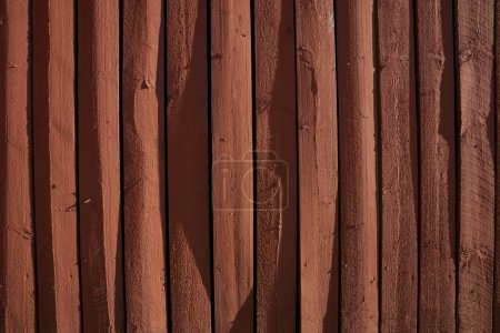 Photo for Background with weathered rustic red wooden plank in bright sunshine, giving three dementional impression - Royalty Free Image