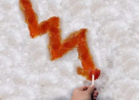 Maple syrup shortage and decline of Sugar Shack Maple taffy or sweet boiled tree sap as a downward chart arrow on snow as a traditional spring season food culture from Quebec Ontario Canada and New England.