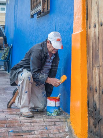 Photo for Bogota, Colombia - September 13, 2013: Colombian man is painting the wall on the street of Bogota - Royalty Free Image