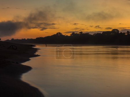 Photo for Sunrise over the Javarii  river, tributary of the Amazon. Sandy beach in Amazon jungle, during the low water season. Amazonia. Selva on the border of Brazil and Peru. South America. Dos Fronteras. - Royalty Free Image
