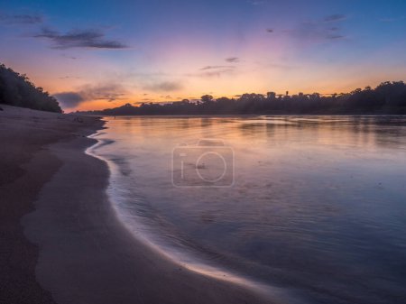 Photo for Sunrise over the Javarii  river, tributary of the Amazon. Sandy beach in Amazon jungle, during the low water season. Amazonia. Selva on the border of Brazil and Peru. South America. Dos Fronteras. - Royalty Free Image