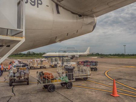 Photo for Iquitos, Peru - December 07, 2018: Luggage is waiting to be loaded onto an airplane at Iquitos airport. South America, Latin America - Royalty Free Image