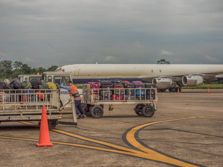 Photo for Iquitos, Peru - December 07, 2018: Luggage is waiting to be loaded onto an airplane at Iquitos airport. South America, Latin America - Royalty Free Image