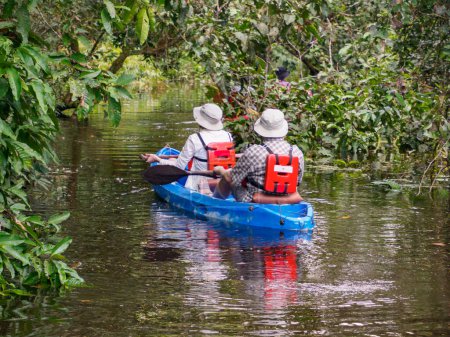 Photo for Pacaya Samiria National Reserve, Peru - Apr, 2022: Tourists on kayaks exploring the Yarapa River tributary of the Ucayali River in the Amazon rainforest. Ecotourism concept. Amazonia. South America - Royalty Free Image