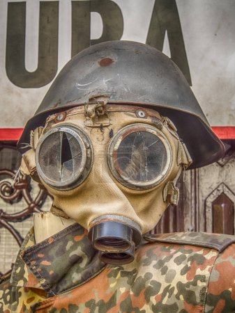 Photo for Destroyed gas mask, helmet and uniform of the soldier presented on the street - Royalty Free Image