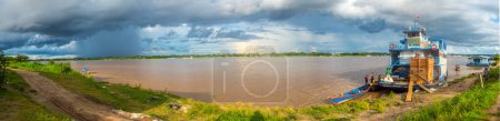 Photo for Amazon River, Peru - December 04 , 2018:  Panoramic view of ferry boat on the bank of the Amazon River. South America. - Royalty Free Image