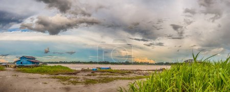 Photo for Amazon River, Peru - December 04 , 2018:  Panoramic view of wooden house on the bank of the Amazon River. Santa Rosa. South America. - Royalty Free Image