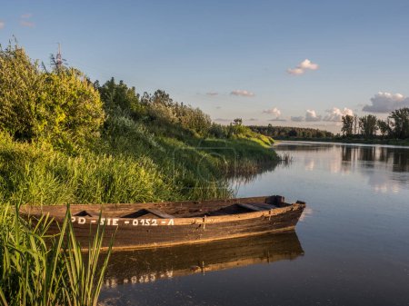 Photo for Wooden boats at the bank of the Bug River.  Drohiczyn. Podlasie. Podlachia. Poland, Europe. The region is called Podlasko or Podlasze - Royalty Free Image