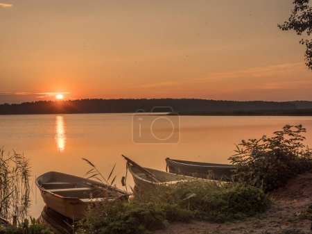 Photo for Wooden and metal boats at the on the lake Lake Jezioro Dbrowa M Dabrowno, Poland - Royalty Free Image