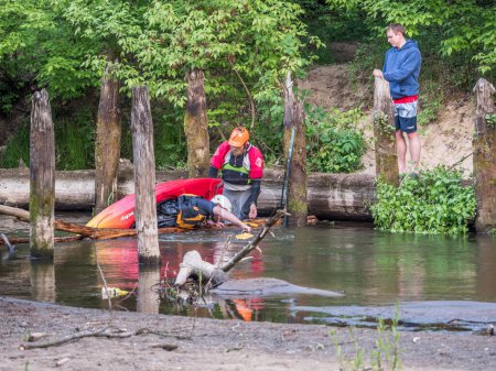 Photo for Jzefw, Poland - May 12: canoeing, extreme kayaking The guy in a small sport kayak is practicing with coach how to overcome a difficult obstacle on the Swider River in Poland - Royalty Free Image