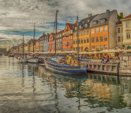 Photo for Nyhavn (New Harbour), Copenhagen, Denmark - 14 JMay 2019: Panoramic view of Nyhavn pier with color buildings, ships, yachts and other boats in the Old Town of Copenhagen, Denmark, Europe - Royalty Free Image