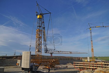 Photo for Folding crane installation in Benkendorf on a bridge construction site for the overpass of a service road over the future A143. - Royalty Free Image