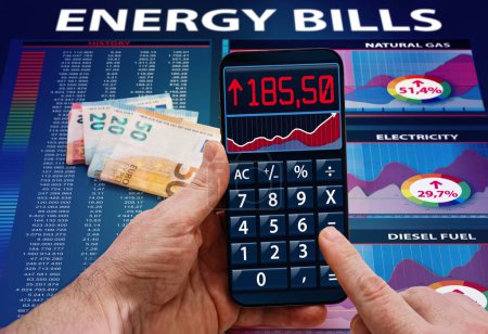 Photo for Man hands with cost calculator application about electric power, gas and fuel costs in the household. Hand with phone calculator app analyzing energy bill expenses, Concept High cost of energy bill - Royalty Free Image