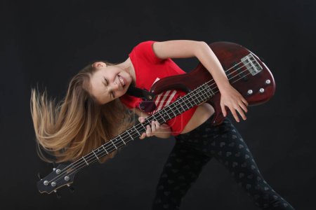Photo for Excited little girl playing bass guitar - Royalty Free Image