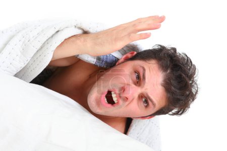 close up of young just woken up angry man screaming 