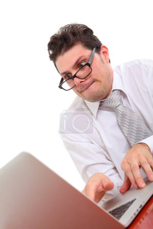 stressed out man with glasses on white background staring at laptop screen 