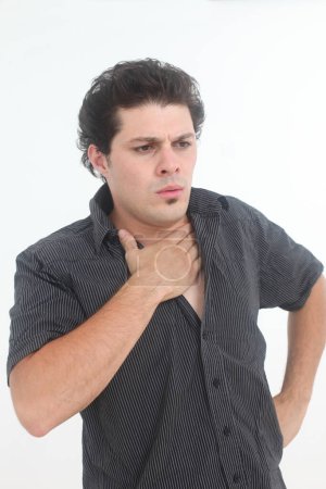 young man feeling unwell  with anxiety touching his chest on white background
