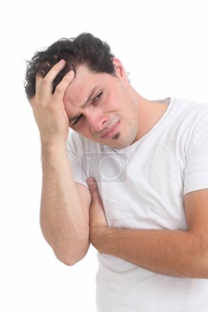 young man feeling unwell touching his head  on white background
