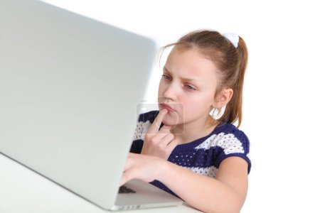 preteen girl using laptop on white background