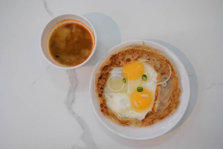 Téléchargez les photos : Une assiette de roti tampal, une version de roti canai ou un pain au prata malaisien. - en image libre de droit
