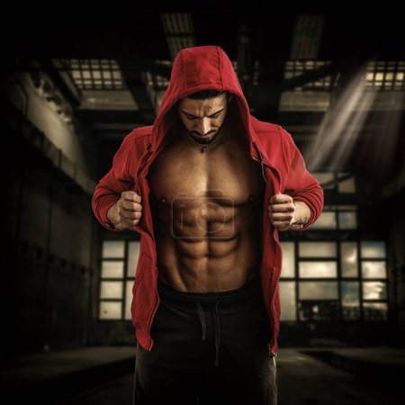 Photo for A shirtless man in a red jacket and black pants - Royalty Free Image
