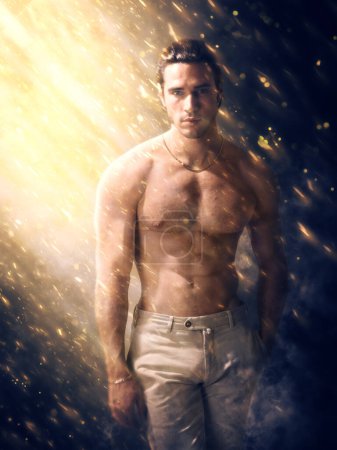 Photo for A man without a shirt is standing in a shower of sparkles and embers - Royalty Free Image