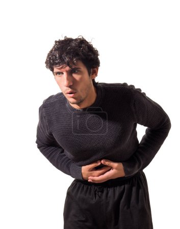 Photo for Confident Young Man Striking a Pose With His Hands on His Stomach, Feeling Unwell, Having a Aching Belly, Illness - Royalty Free Image