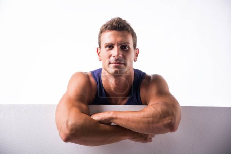Photo for A man is standing in a pose with his arms crossed, looking directly at the camera. He appears confident and assertive in his stance. - Royalty Free Image