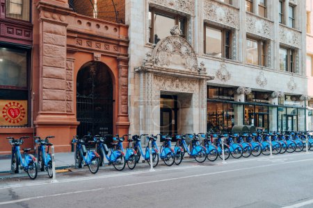 Photo for New York, USA - November 21, 2022: Row of Citi Bikes parked at the docks on a street in New York. Citi Bike is a privately owned public bicycle sharing system serving the city. - Royalty Free Image