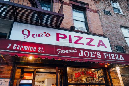 Photo for New York, USA - November 21, 2022: Exterior of Joe's Pizza, an iconic pizza slice restaurant in Greenwich Village that was established in 1975 by Joe Pozzuoli. - Royalty Free Image