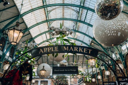 Photo for London, UK - December 26, 2022: Apple Market sign amongst Christmas decorations in Covent Garden Market, one of the most popular tourist sites in London, UK. - Royalty Free Image