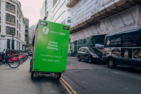Foto de London, UK - February 02, 2023: Delivery Mates van parked on a street in the City of London. Delivery Mates is a last-mile delivery company offering sustainable carbon neutral delivery. - Imagen libre de derechos