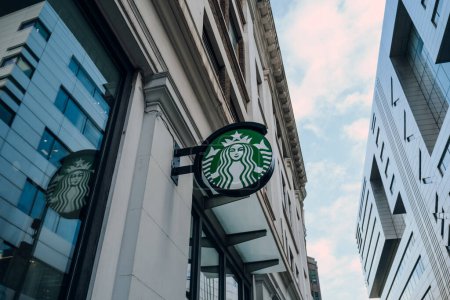 Photo for London, UK - February 02, 2023: Logo sign outside a Starbucks cafe in City of London. Starbucks is a famous American coffeehouse chain. - Royalty Free Image