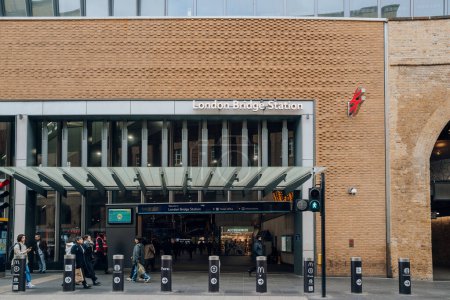 Photo for London, UK - February 02, 2023: People walking in front on London Bridge rail station, the oldest railway station in London zone 1 and one of the oldest in the world, having opened in 1836. - Royalty Free Image