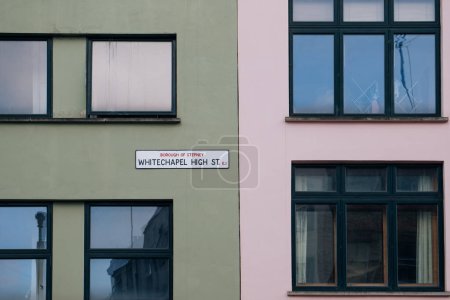 Photo for Street name sign on pastel coloured buildings on Whitechapel High Street in East London, UK. - Royalty Free Image