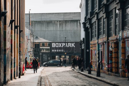 Photo for London, UK - February 09, 2023: View of Boxpark Shoreditch, a shipping container mall for independent fashion and lifestyle stores and cafes, from a nearby street, selective focus on the background. - Royalty Free Image