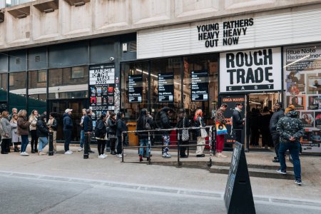 Photo for London, UK - February 09, 2023: People queueing outside Rough Trade music shop inside old brewery with a coffee shop that also sells books and hosts in-store gigs, in Brick Lane, East London - Royalty Free Image