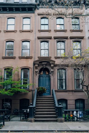 Photo for New York, USA - November 21, 2022: Exterior of a traditional house with a stoop in West Village, a charming area of Manhattan famous for its shops and restaurants. - Royalty Free Image