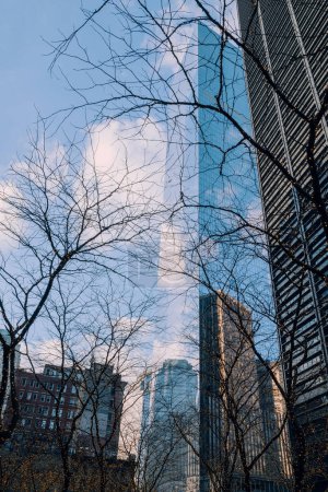 Photo for New York, USA - November 25, 2022: Sky and clous reflecting on a skyscraper in Financial District,  New York's financial heart and a home to Wall Street. - Royalty Free Image