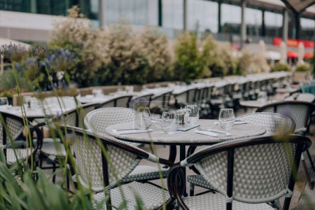 Photo for Set outdoor restaurant tables and chairs in London, UK, selective focus. - Royalty Free Image