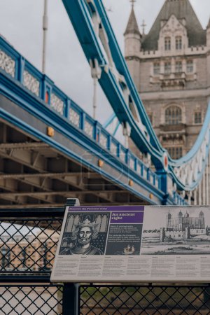 Photo for London, UK - July 06, 2023: Sign showcasing the Tower of London history, Tower Bridge on the background. Tower of London and tower Bridge are one of the most popular landmarks in London. - Royalty Free Image